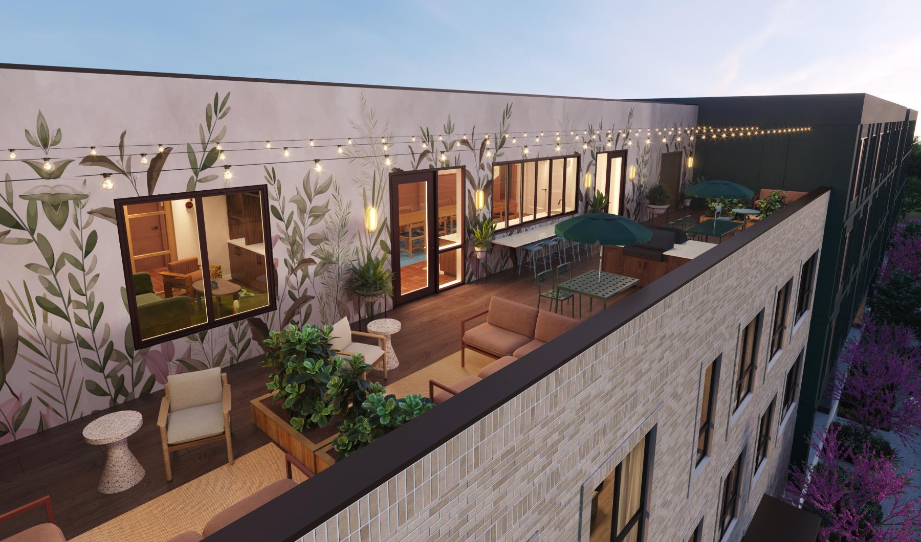 a rooftop deck with couches, tables and chairs